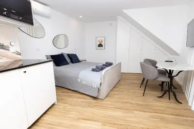 a bedroom with a bed and a table in a room at Trindade Trendy Studio 15 in Porto