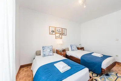a bedroom with two beds with blue and white sheets at GuestReady - Eclectic haven in the heart of Porto in Porto