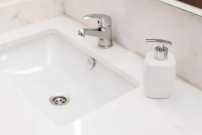 a bathroom sink with a faucet and a soap dispenser at GuestReady - Eclectic haven in the heart of Porto in Porto