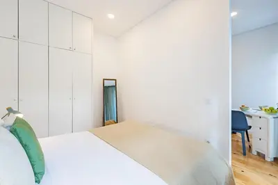 a white bathroom with a shower and a toilet at Urban Studio @ Bonfim in Porto