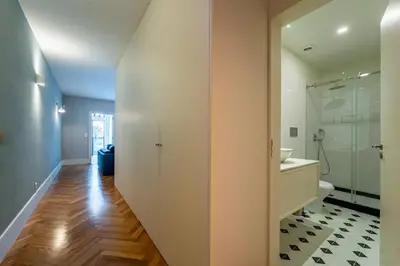 a white bathroom with a sink and a container with bottles and a hot dog at Intimate Apartment Downtown With Terrace - D in Porto