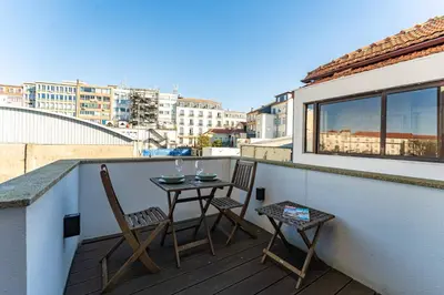a balcony with two chairs and a table on it at Oporto Chic and Glamorous Downtown with Terrace-F in Porto