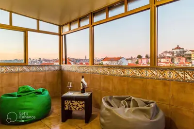 a room with a large window with a view of the city at Gaia Riverview in Vila Nova de Gaia