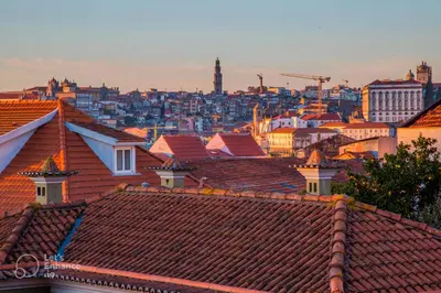 a lit up lighthouse in a city at night at Gaia Riverview in Vila Nova de Gaia