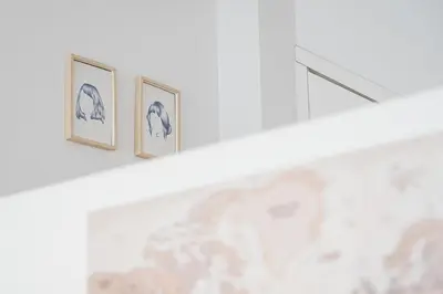 a shelf with three framed pictures on a wall at GuestReady - A lovely city retreat in Porto