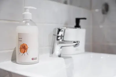 a bottle of detergent sitting on a bathroom sink at GuestReady - A lovely city retreat in Porto