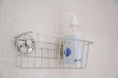a bottle of detergent in a holder on a bathroom wall at GuestReady - A lovely city retreat in Porto