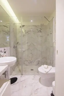 a bathroom with a shower and a toilet and a sink at Oporto Exquisite Apartment in Porto