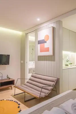 a bedroom with a bench in the middle of a room at Oporto Exquisite Apartment in Porto