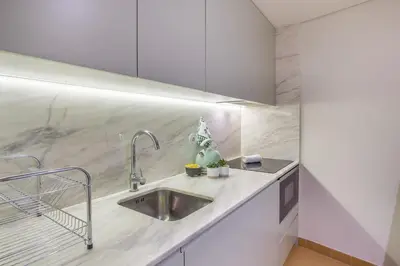 a kitchen with a sink and a counter top at Oporto Exquisite Apartment in Porto