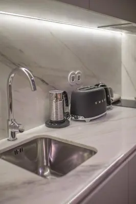 a kitchen counter with a sink and a toaster at Pleasant Studio Santa Catarina in Porto