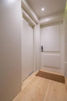 an empty room with a door and a wooden floor at Pleasant Studio Santa Catarina in Porto