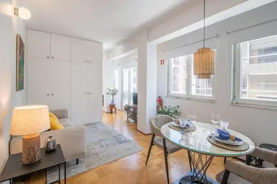 a living room with a table and a couch at PS70 Apartments I in Porto