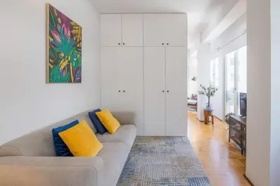 a living room with a gray couch and yellow pillows at PS70 Apartments I in Porto