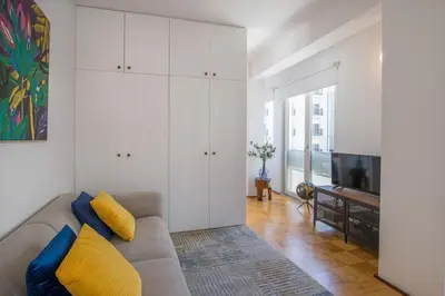 a living room with a couch and a television at PS70 Apartments I in Porto