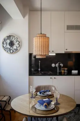 a dining room table with a chandelier hanging over it at PS70 Apartments I in Porto