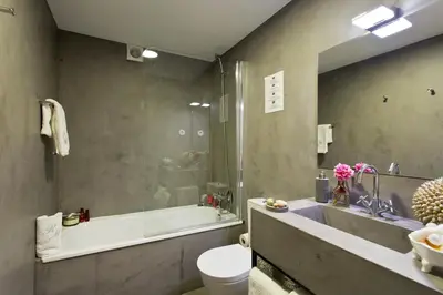 a bathroom with a tub and a sink and a toilet at Ribeira Memories 72 in Porto