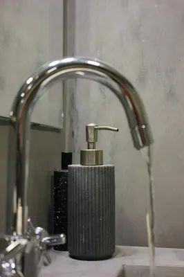 a bathroom sink with a faucet and a soap dispenser at Ribeira Memories 72 in Porto