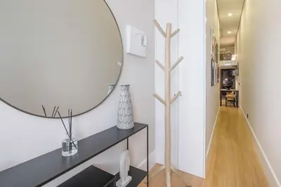 a bathroom with a large mirror on the wall at Tailor's Apartments II in Porto