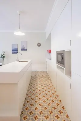 a kitchen with white counters and a tile floor at Virginie Almada Apartment in Porto