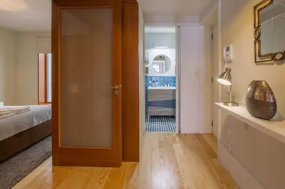 a door leading to a bedroom with a bed at Virginie Almada Apartment in Porto