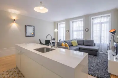 a kitchen with a sink and a couch in a living room at Virginie Almada Apartment in Porto