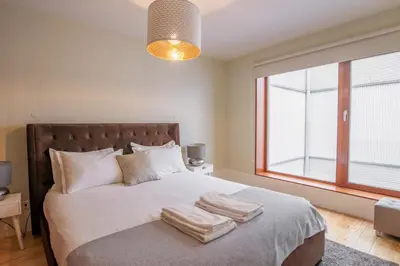 a bedroom with a large bed with towels on it at Virginie Almada Apartment in Porto