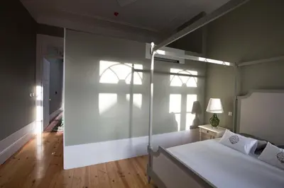 a bedroom with a large bed and a window at Porto Vintage Guesthouse in Porto