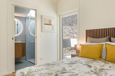 a bedroom with a large bed with yellow pillows at Valadouro Duplex Factory - Maison dans Porto in Porto