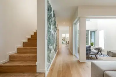 a living room with a staircase in a house at Valadouro Duplex Factory - Maison dans Porto in Porto