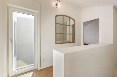 a white bathroom with a mirror and a window at Valadouro Duplex Factory - Maison dans Porto in Porto