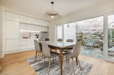 a kitchen and dining room with a table and chairs at Valadouro Duplex Factory - Maison dans Porto in Porto