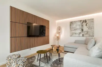 a living room with a couch and a tv at Valadouro Duplex Factory - Maison dans Porto in Porto