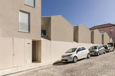 a row of parked cars parked next to a building at Valadouro Duplex Factory - Maison dans Porto in Porto