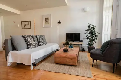 a living room with a couch and a coffee table at Downtown Urban Nest in Porto