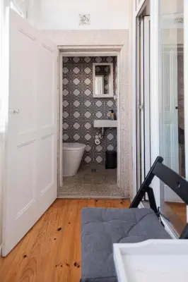 a room with a bathroom with a tub and a door at Downtown Urban Nest in Porto