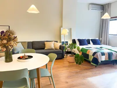 a living room with a couch and a table at Casa Agustina, Central and sunny Studio with optional Parking in Porto