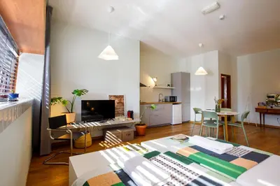 a living room with a table and a couch at Casa Agustina, Central and sunny Studio with optional Parking in Porto