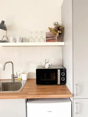 a black microwave on a counter in a kitchen at Casa Agustina, Central and sunny Studio with optional Parking in Porto