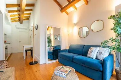 a living room with a blue couch and a table at HostWise - Stylish Retreat in Porto's Heart in Porto