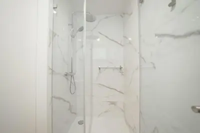 a bathroom with a shower with a glass door at Carmo Residence Porto by Vacationy in Porto