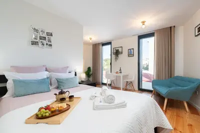 a room with a bed with a tray of fruit on it at Stylish Studio in Porto Downtown by HostWise in Porto