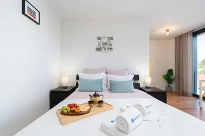 a bedroom with a bed with a tray of fruit on it at Stylish Studio in Porto Downtown by HostWise in Porto