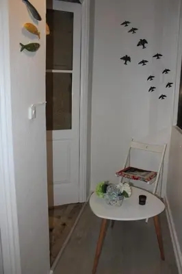 a room with a table and a chair with bats on the wall at Downtown Classic Apartment in Porto