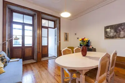 a dining room with a table and chairs at Downtown Classic Apartment in Porto