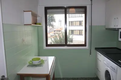 a kitchen with a coffee cup on a table with a window at Downtown Classic Apartment in Porto