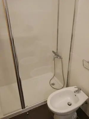 a bathroom with a shower and a toilet and a sink at Casa do Sol in Porto