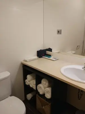 a bathroom with a sink and a counter with towels at Casa do Sol in Porto