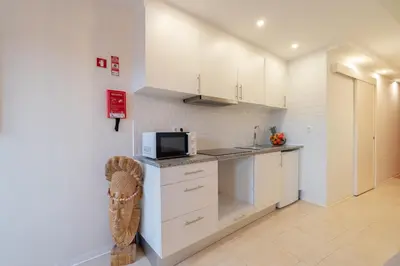 a kitchen with white cabinets and a microwave at HostWise - Artistic Escape with Modern Comfort in Vila Nova de Gaia