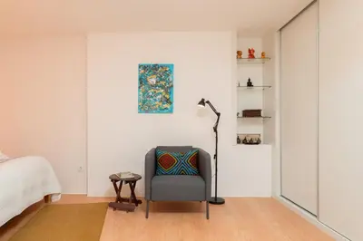 a bedroom with a chair and a lamp at HostWise - Artistic Escape with Modern Comfort in Vila Nova de Gaia
